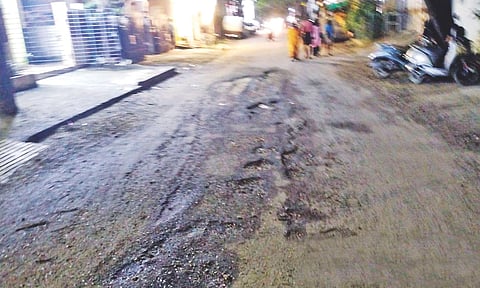 A battered patch of road awaits the attention of civic authorities