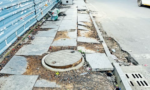 Damaged footpath seen on the busy Poonamallee High Road in Arumbakkam