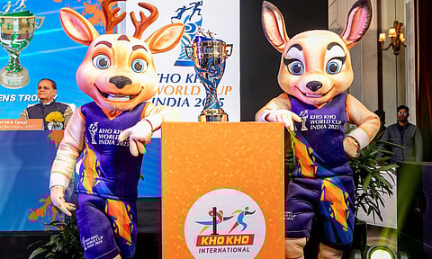 The official mascots of the Kho Kho World Cup pose with the trophy 