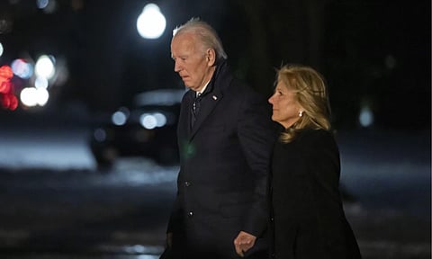 President Joe Biden and first lady Jill Biden walk from Marine One as they arrive back at the South Lawn of the White House (AP)