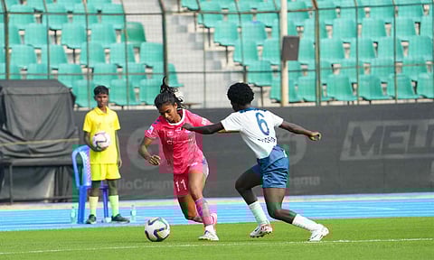 Goalscorer Malavika P dribbles past a defender during the match