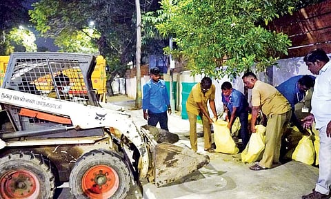 Cleanliness workers from the Corporation clear garbage and other debris from a footpath on Greenways Road on Tuesday