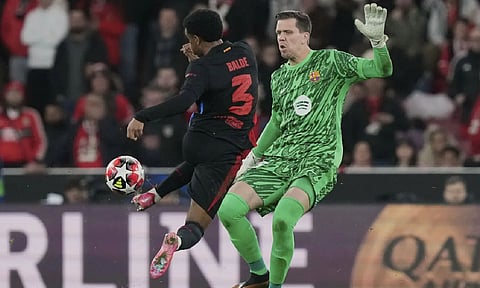 Barcelona's Alejandro Balde collides with Barcelona's goalkeeper Wojciech Szczęsny during a Champions League opening phase soccer match (AP)