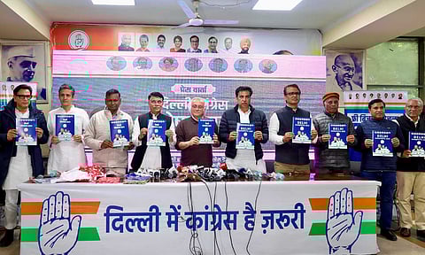 In this image provided by AICC, Congress leaders Jairam Ramesh, Pawan Khera and others launch the party's manifesto for the Delhi Assembly election, at DPCC Office in New Delhi, Wednesday, Jan. 29, 2025 (PTI) 