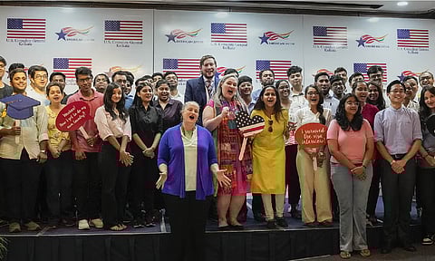 US Consul General Melinda Pavek (C) with students poses for photographs after their visa interview during the annual Student Visa Day event, in Kolkata, June 13, 2024. (PTI)