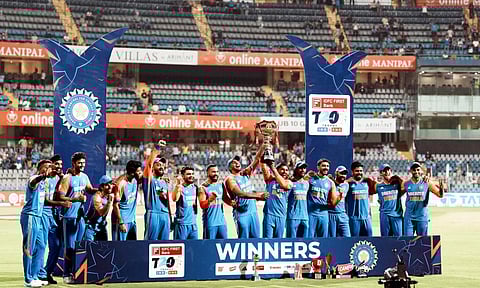 Indian players pose for picture with the trophy after winning the fifth Twenty20 cricket match and series against England at Wankhede Stadium, in Mumbai (PTI)