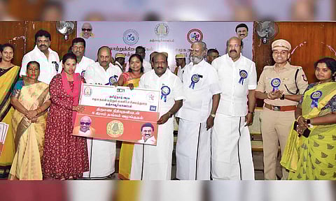 Chezhiaan handing over aid to a beneficiary on Friday 