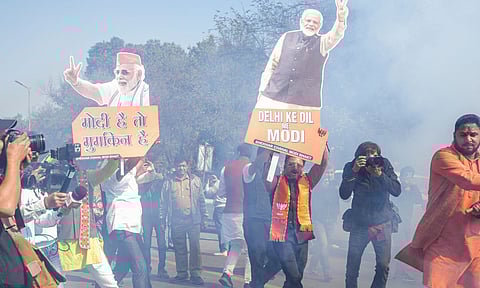  BJP supporters celebrate the party's decisive lead in the Delhi Assembly polls as counting of votes is underway, at BJP office in New Delhi (PTI)