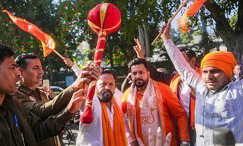 BJP workers celebrate outside the residence of Aam Aadmi Party (AAP) chief and candidate from New Delhi constituency Arvind Kejriwal, amid the counting of votes for Delhi Assembly elections, in New Delhi (PTI) 