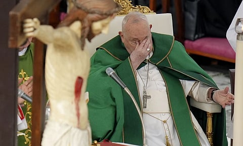 Pope touches his eyes as he presides over a mass for the jubilee of the armed forces in St. Peter's Square at The Vatican (AP)