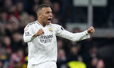 Real Madrid's Kylian Mbappe celebrates after scoring his side's first goal during a Spanish La Liga soccer match between Real Madrid and Atletico Madrid at the Santiago Bernabeu stadium in Madrid (AP)