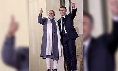 PM Narendra Modi is greeted by President of France Emmanuel Macron as he arrives for a reception at Elysee Palace in Paris (PTI) 