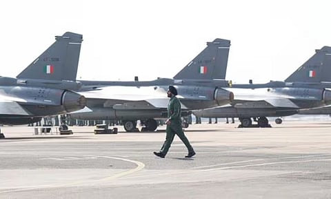 An Army personnel walks by aircraft parked ahead of the Aero India 2025 (PTI)