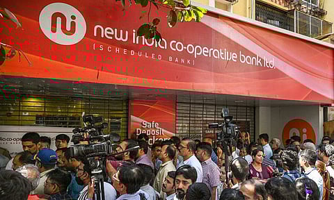 A security personnel keeps vigil at a deserted New India Cooperative Bank (PTI)