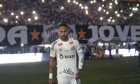 Brazil’s Neymar walk onto the pitch during his debut for Santos FC in a Sao Paulo league soccer match against Botafogo-SP, in Santos