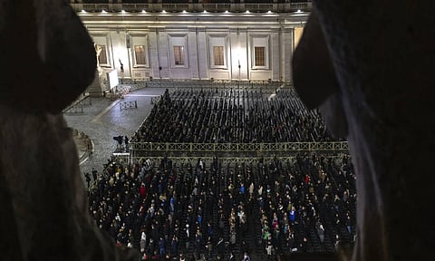 Catholic faithful attend a nightly rosary prayer service for the health of Pope Francis in St. Peter's Square at the Vatican (AP) 