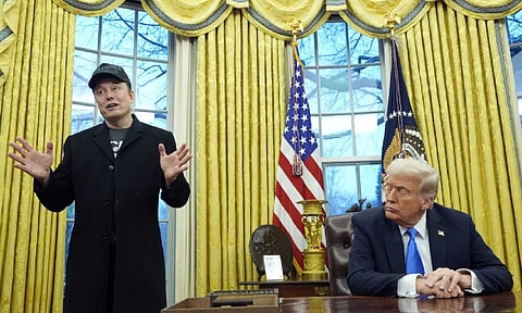 President Donald Trump listens as Elon Musk speaks in the Oval Office at the White House (AP)
