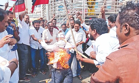 DMK workers burning Union Minister Dharmendra Pradhan’s effigy at Tiruchy central bus stand on Monday