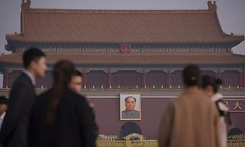 Journalists wait for the arrival of delegates at Tiananmen Square before the closing session of the Chinese People's Political Consultative Conference (CPPCC) in Beijing (AP)