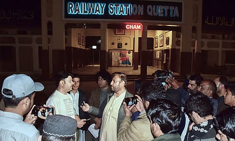 Relatives of passengers of a train, which is attacked by insurgents, gather to get information about passengers from special counter at a railway station in Quetta, Pakistan (AP)