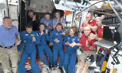 NASA shows astronauts greeting each other after a SpaceX capsule docked with the International Space Station (AP)