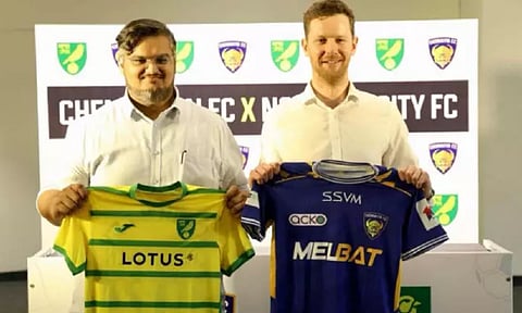 Ekansh Gupta, VP Chennaiyin FC and Sam Jeffery from Norwich pose with club shirts 