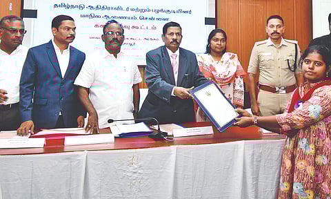 TN SC/ST commission chairperson S Tamilvanan distributes welfare assistance to a beneficiary, in Thanjavur, on Wednesday