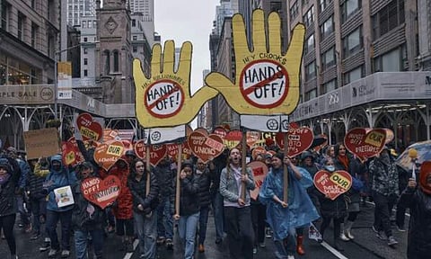 26 Protestors shout slogans as they march during a "Hands Off!" protest against President Donald Trump (AP)