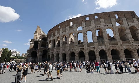 Tourists wait in a queue to enter the Colosseum in Rome, Italy (AP)
