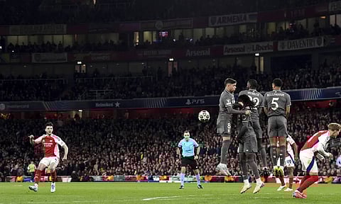 Arsenal's Declan Rice, left, scores his side's opening goal during the Champions League quarterfinal first leg soccer match between Arsenal and Real Madrid at the Emirates stadium in London (AP) 