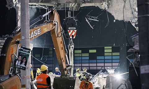 Rescue workers search for survivors at the Jet Set nightclub after its roof collapsed two nights before during a merengue concert in Santo Domingo