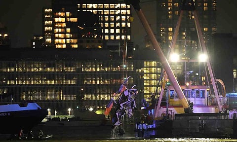 A crane vessel lifts the wreckage of a helicopter that crashed into the Hudson River, Thursday (AP)