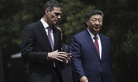 Chinese President Xi Jinping, right and Spanish Prime Minister Pedro Sanchez speak as they walk along the gardens of Diaoyutai Guest House after a meeting in Beijing, China (AP)