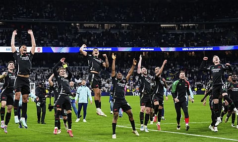 Arsenal players celebrate after defeating Real Madrid (AP)