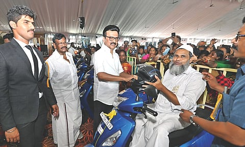 CM Stalin handing over welfare assistance to a beneficiary 