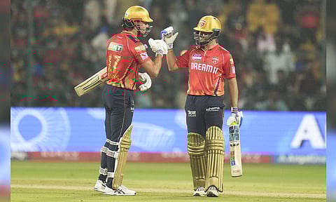 Punjab Kings' Nehal Wadhera and M Stoinis celebrate their win in the Indian Premier League (IPL) 2025 cricket match against Royal Challengers Bengaluru at M Chinnaswamy Stadium (PTI) 