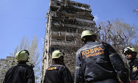 Rescue workers inspect a multi-storey building damaged by Russian strike on residential neighborhood in Zaporizhzhia, Ukraine (AP)
