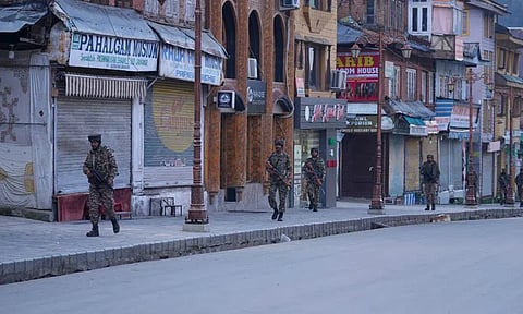 Security officers patrol a shopping area in Pahalgam (Photo: AP)