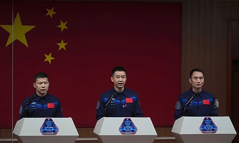 Astronauts for the upcoming Shenzhou 20 mission captain Chen Dong, center, Wang Jie, left and Chen Zhongrui meet with the press at the Jiuquan Satellite Launch Center in northwest, China (AP)