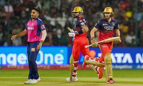 Virat Kohli and Phil Salt run between the wickets as Rajasthan Royals' Tushar Deshpande looks on during the Indian Premier League (IPL) 2025 cricket match between RCB and RR, at M Chinnaswamy stadium in Bengaluru (PTI) 