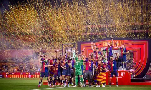 Barcelona players celebrate with the trophy after winning the Spanish Copa del Rey final soccer match between Barcelona and Real Madrid at Estadio de La Cartuja stadium in Seville (AP)
