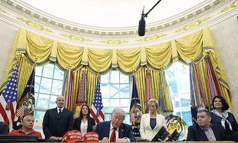 President Donald Trump signs an executive order (AP)