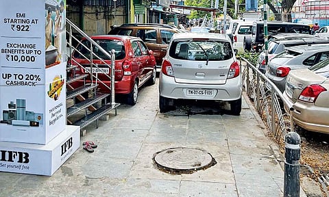 A row of cars parked on one of the pavements on Jawaharlal Nehru Road on Tuesday