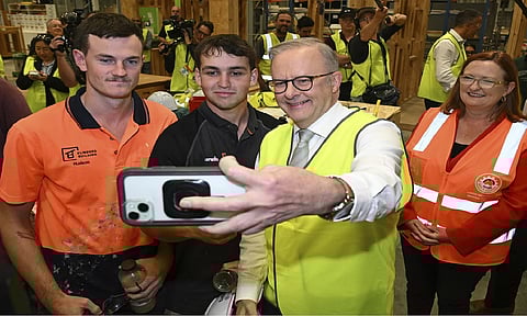 Australian PM Anthony Albanese, center, takes a selfie with apprentice carpenters while visiting Technical and Further Education (TAFE) Tonsley campus in Adelaide, Thursday, May 1, 2025 (AP)