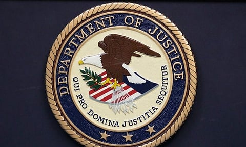 The Department of Justice seal is seen during a press conference (AP) 