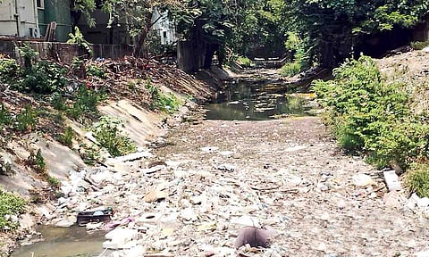 Flow of the canal blocked by waste near Anderson Road