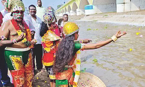 Devotees dressed as deities welcoming the arrival of Vaigai river inflow into Madurai on Saturday