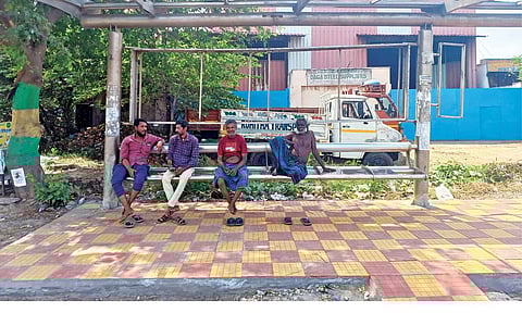 Public wait under roofless bus stop in Jothi Nagar 