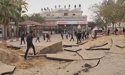 Palestinians inspect the site of an Israeli army airstrike on the European hospital in Khan Younis, Gaza Strip (AP)