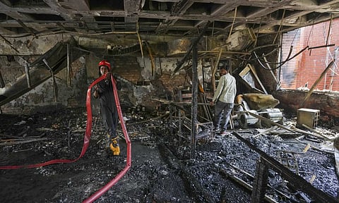 A firefighter at the site after a fire broke out in the library of Guru Gobind Singh College of Commerce, in northwest Delhi's Pitampura, Thursday, May 15, 2025 (PTI) 